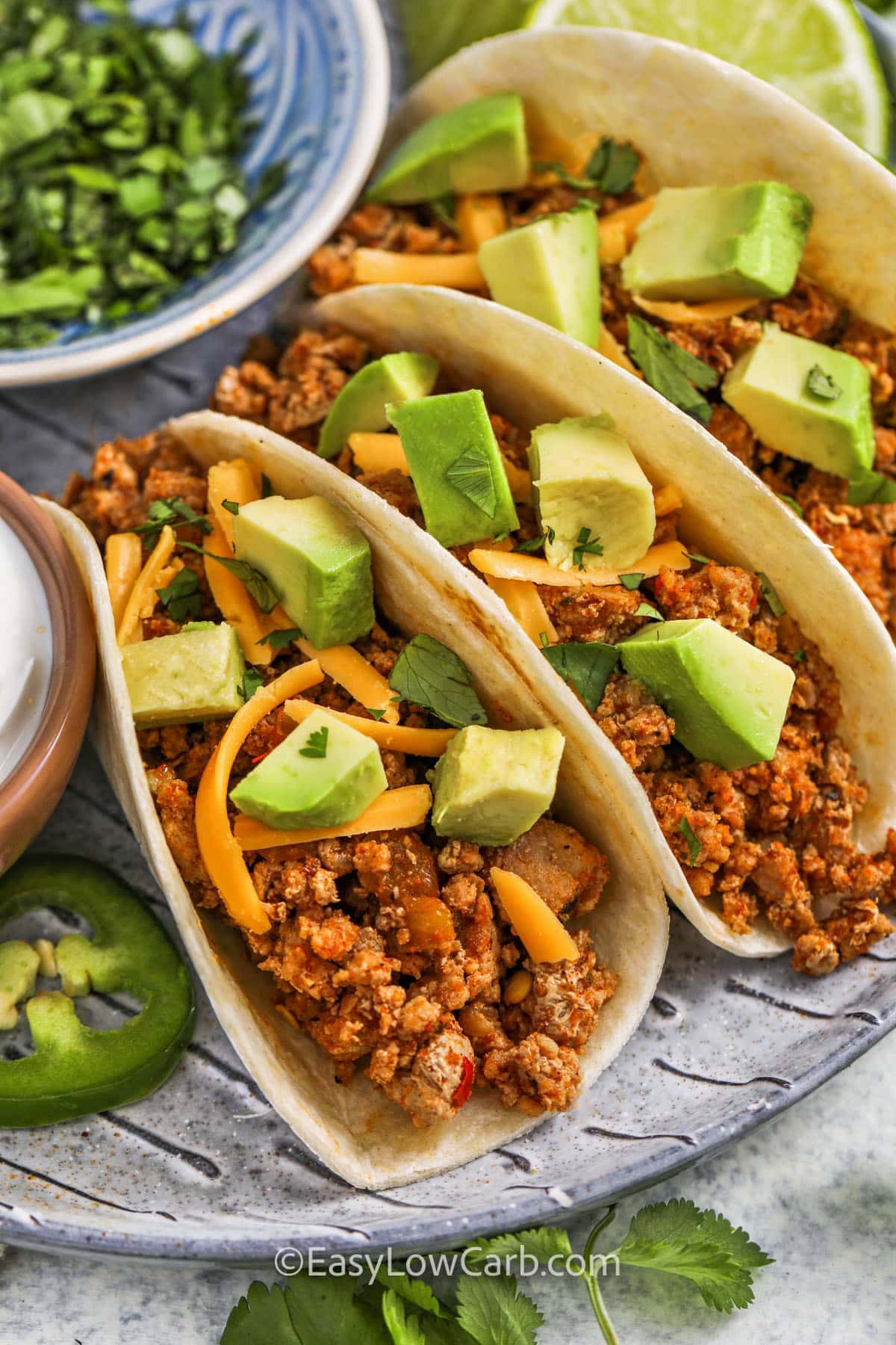 plated Ground Turkey Tacos with avocado and cheese