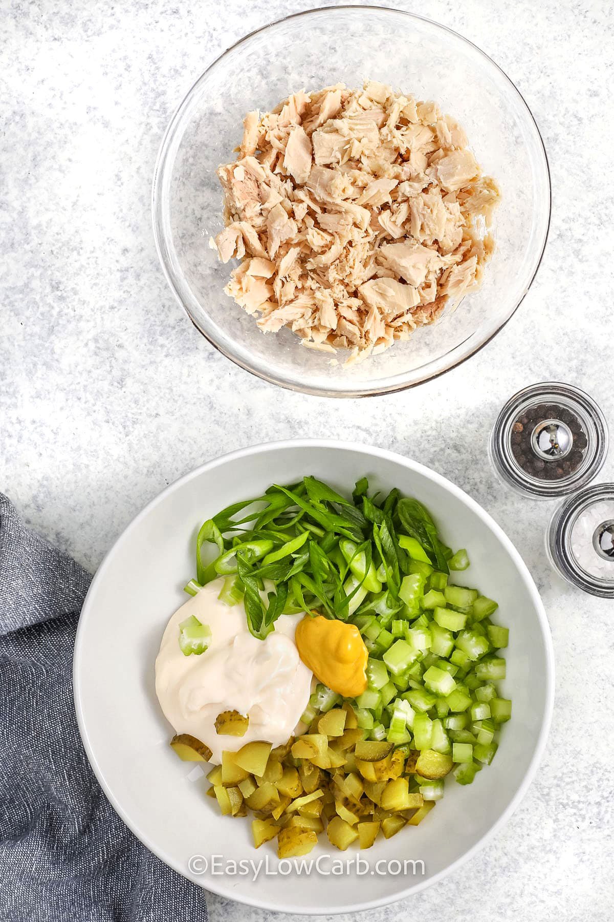 ingredients in a bowl to make Keto Tuna Salad with a bowl of tuna beside it