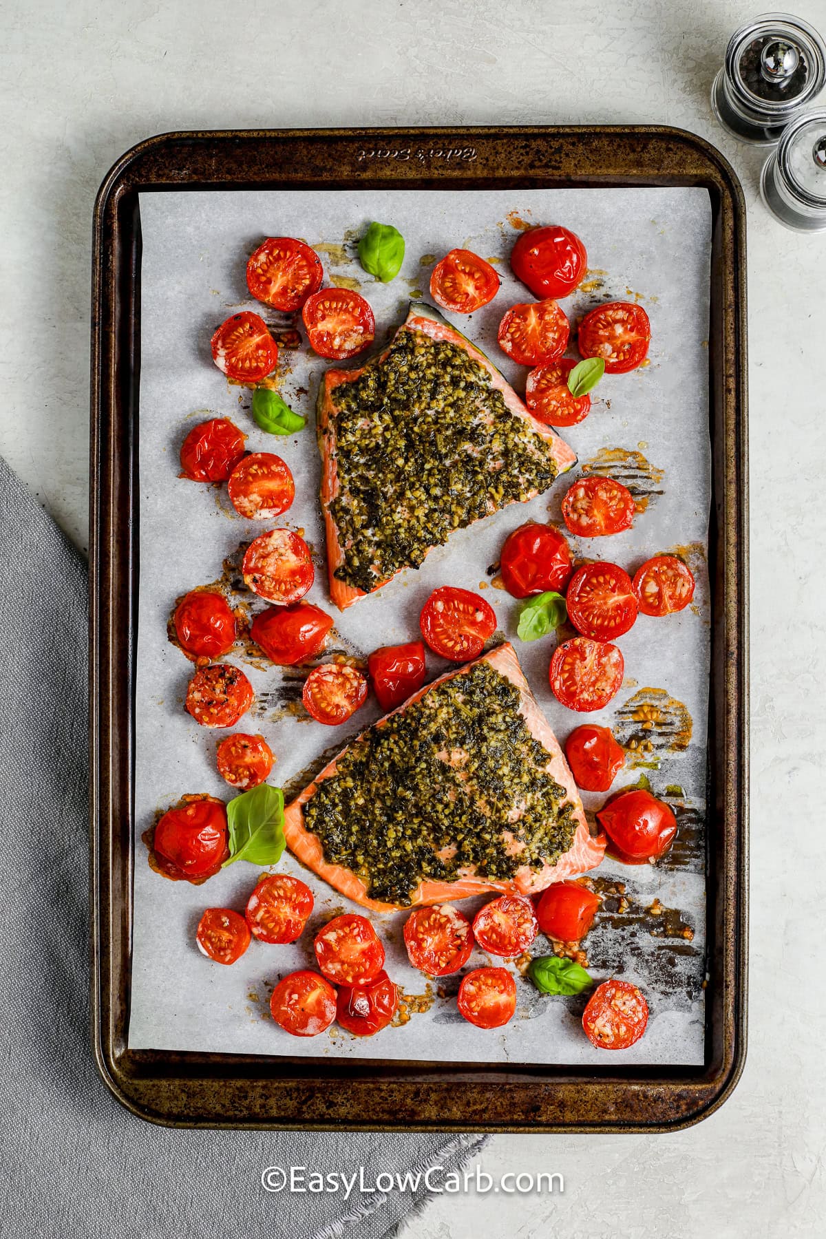 sheet pan with cooked Pesto Salmon Recipe and tomatoes