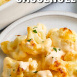 close up of plated Cheesy Cauliflower Casserole with a title