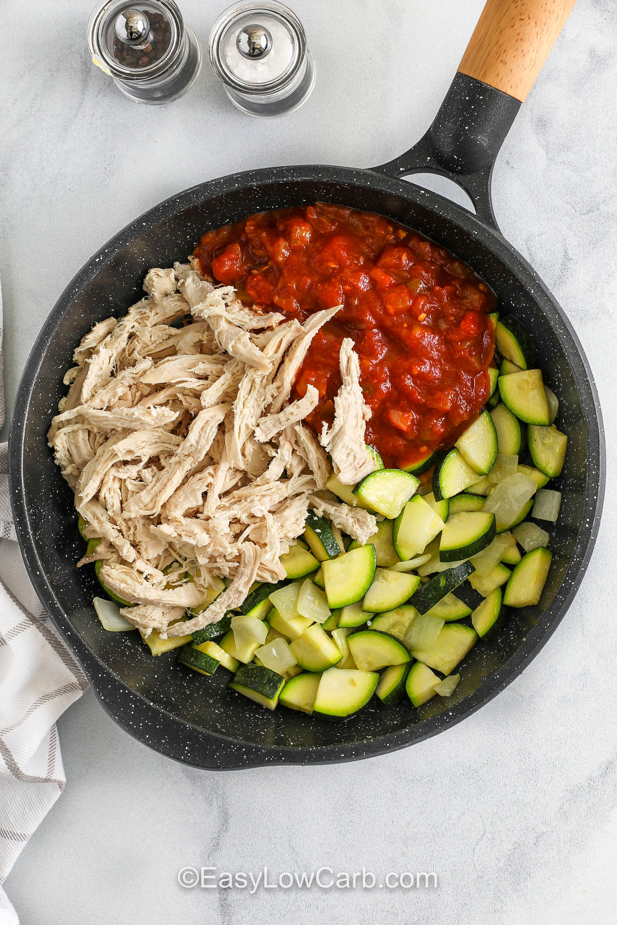 chicken , salsa and vegetables in a pan to make filling for Chicken Stuffed Peppers