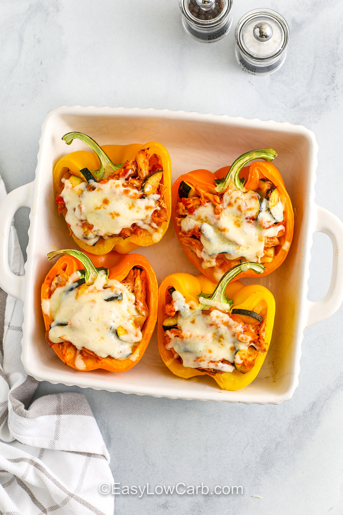 casserole dish of baked cheesy Chicken Stuffed Peppers