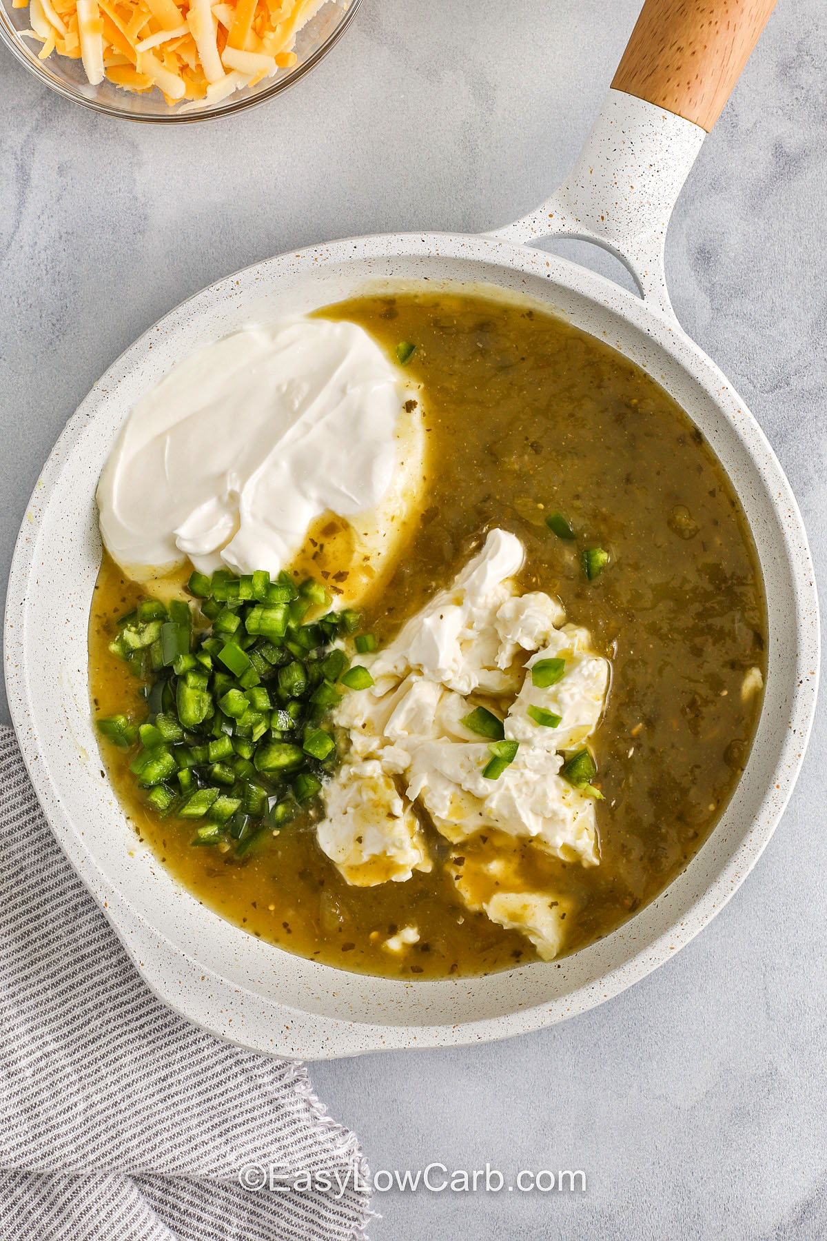 adding igredients together in pot to make sauce for Creamy Chicken Enchiladas