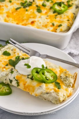 close up of Creamy Chicken Enchiladas with one on a plate