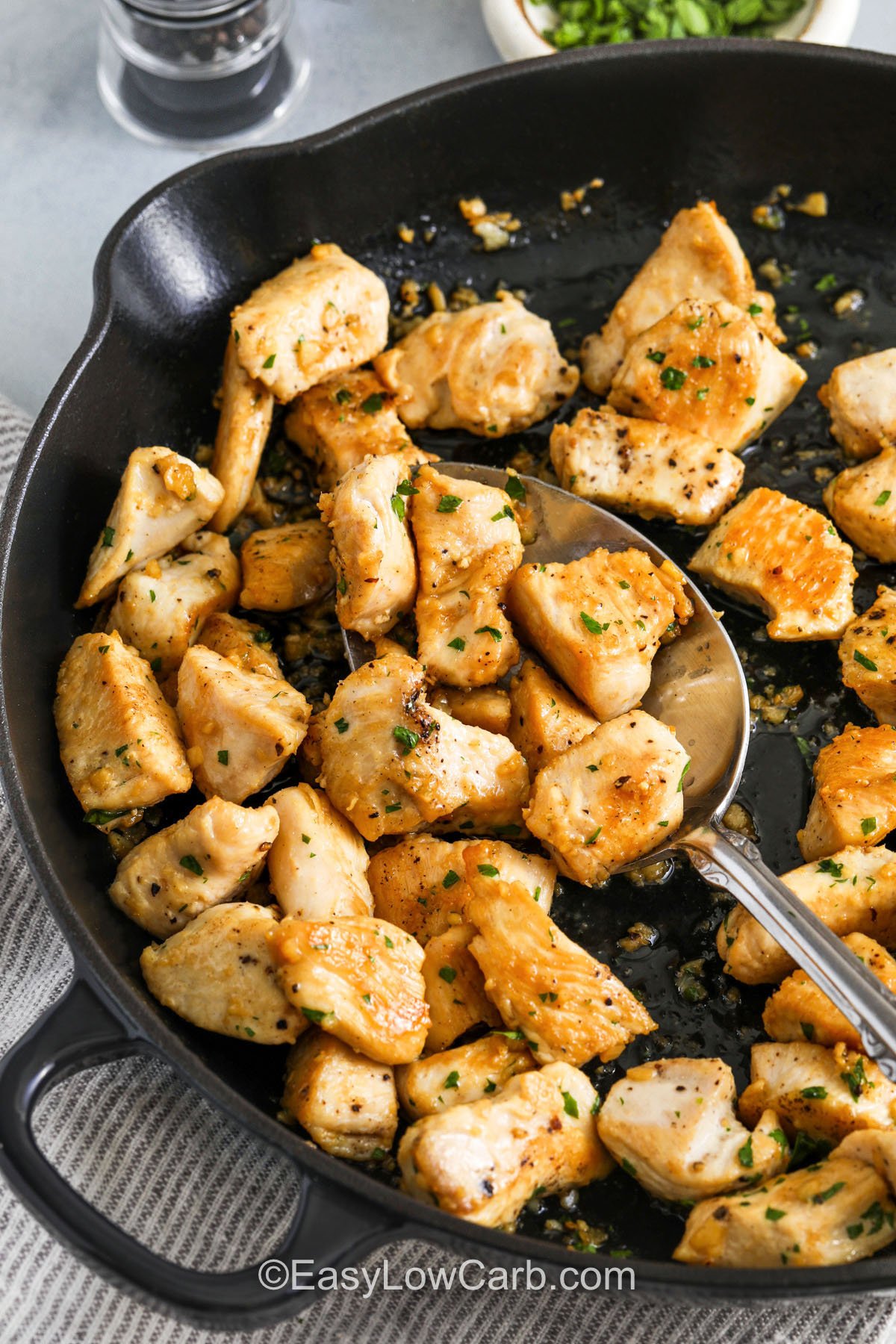 Garlic Butter Chicken Bites in a pan with a spoon
