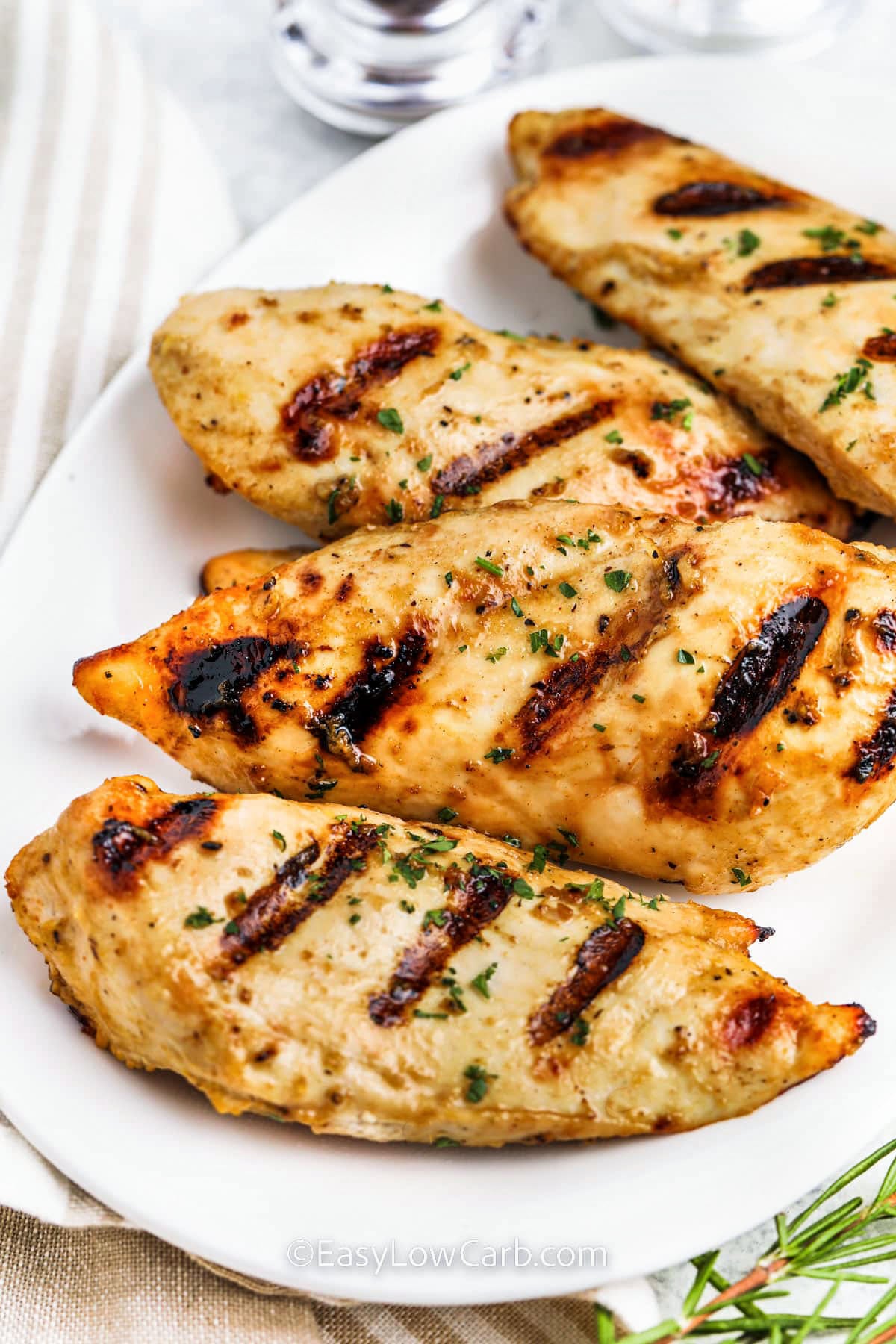 These easy grilled chicken breasts are packed with fresh lemon flavor, savory Worcestershire, and the rich tang of Dijon mustard. The ingredient list is short, but the finished chicken tastes like more than the sum of its parts. This is the kind of dinner recipe that works for busy evenings because it cooks quickly and leaves you with leftovers that are just as useful the next day in bowls, salads, and wraps. #easylowcarb plated Grilled Chicken Breasts