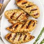 Top view of a platter of grilled chicken breasts