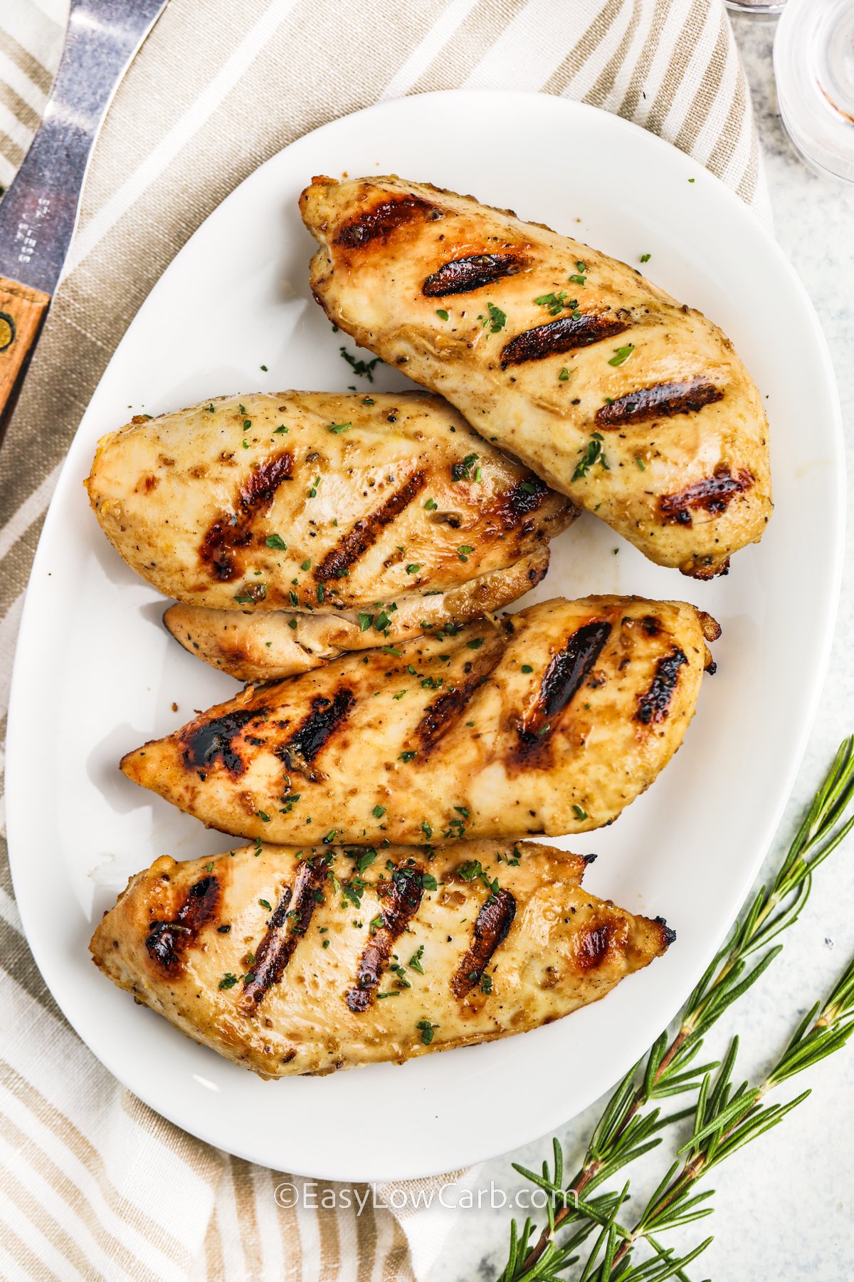 Top view of a platter of grilled chicken breasts