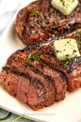 sliced Grilled Sirloin Steak on a plate with butter