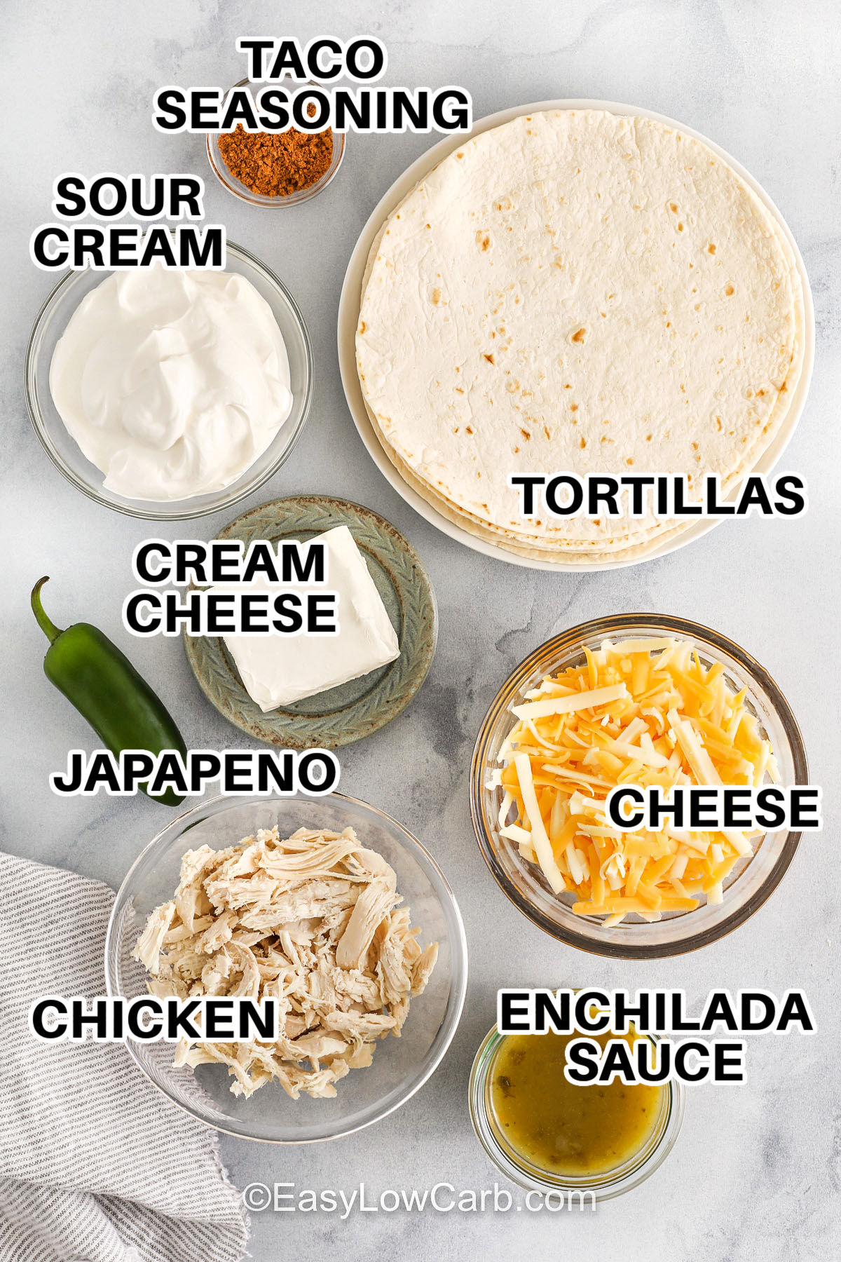 tortillas , sour cream ,taco seasoning ,cream cheese , jalapeno , chicken , enchilada sauce and cheese with labels to make Creamy Chicken Enchiladas