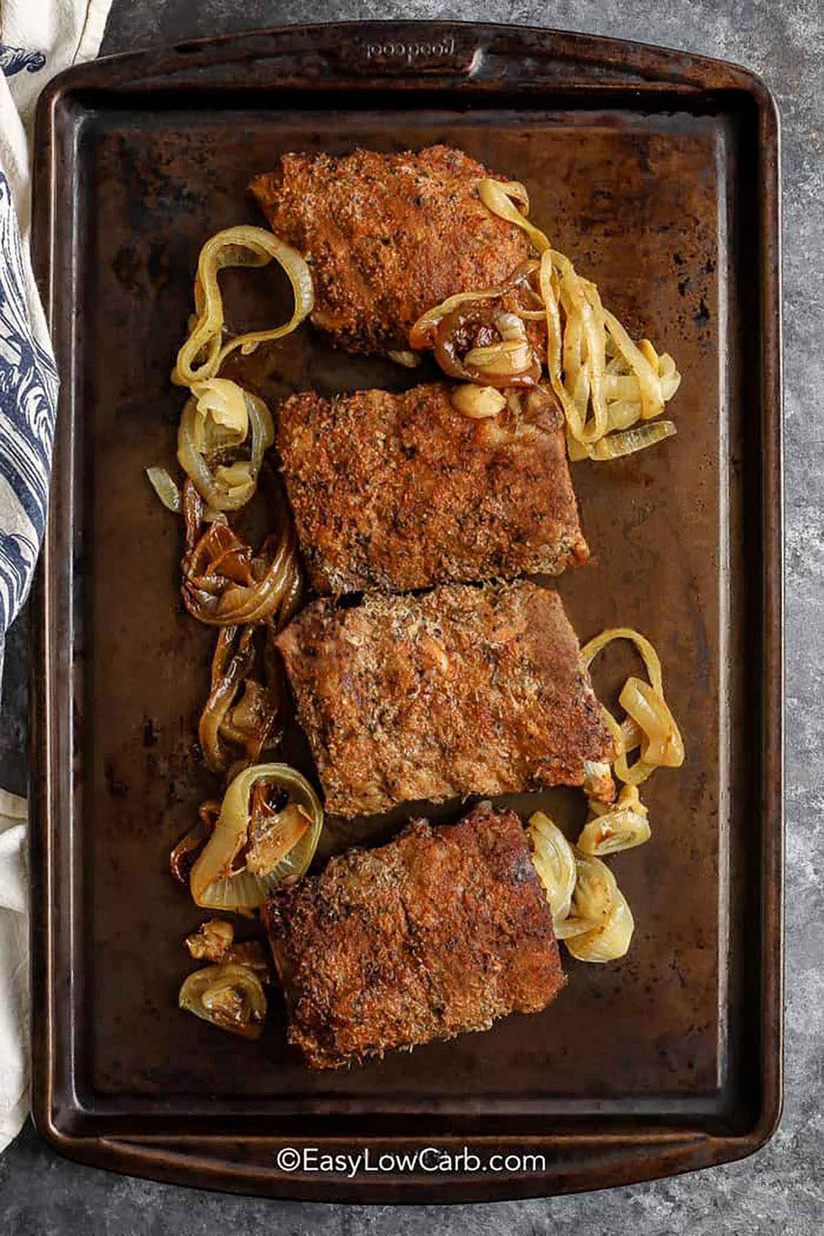 Oven Baked Ribs Recipe and onions on a sheet pan