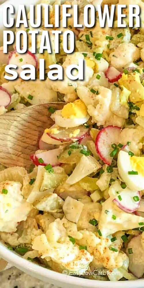 Cauliflower Potato Salad in a bowl with a wooden spoon