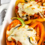 cheesy Chicken Stuffed Peppers in the casserole dish with writing