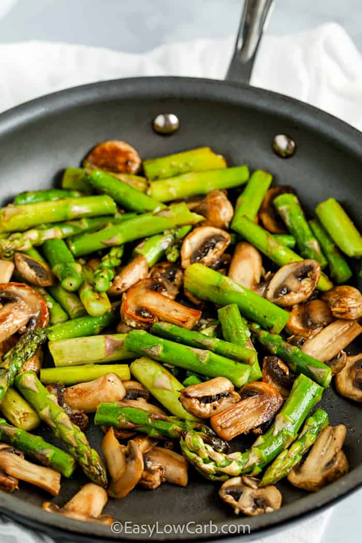 cooking Sauteed Asparagus and Mushrooms in a pan