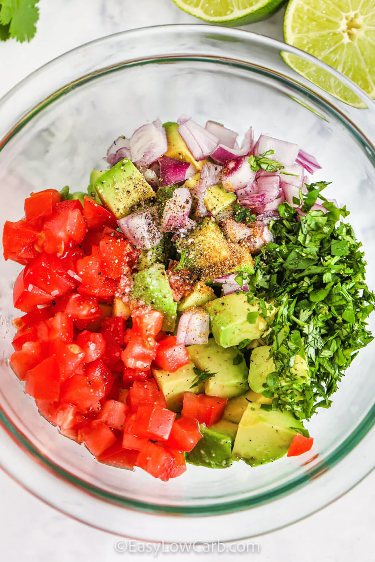 adding ingredients to avocado in bowl to make Avocado Salsa