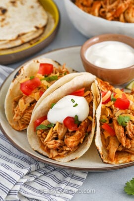 Recipe for Chicken Tacos on a platter with sour cream.