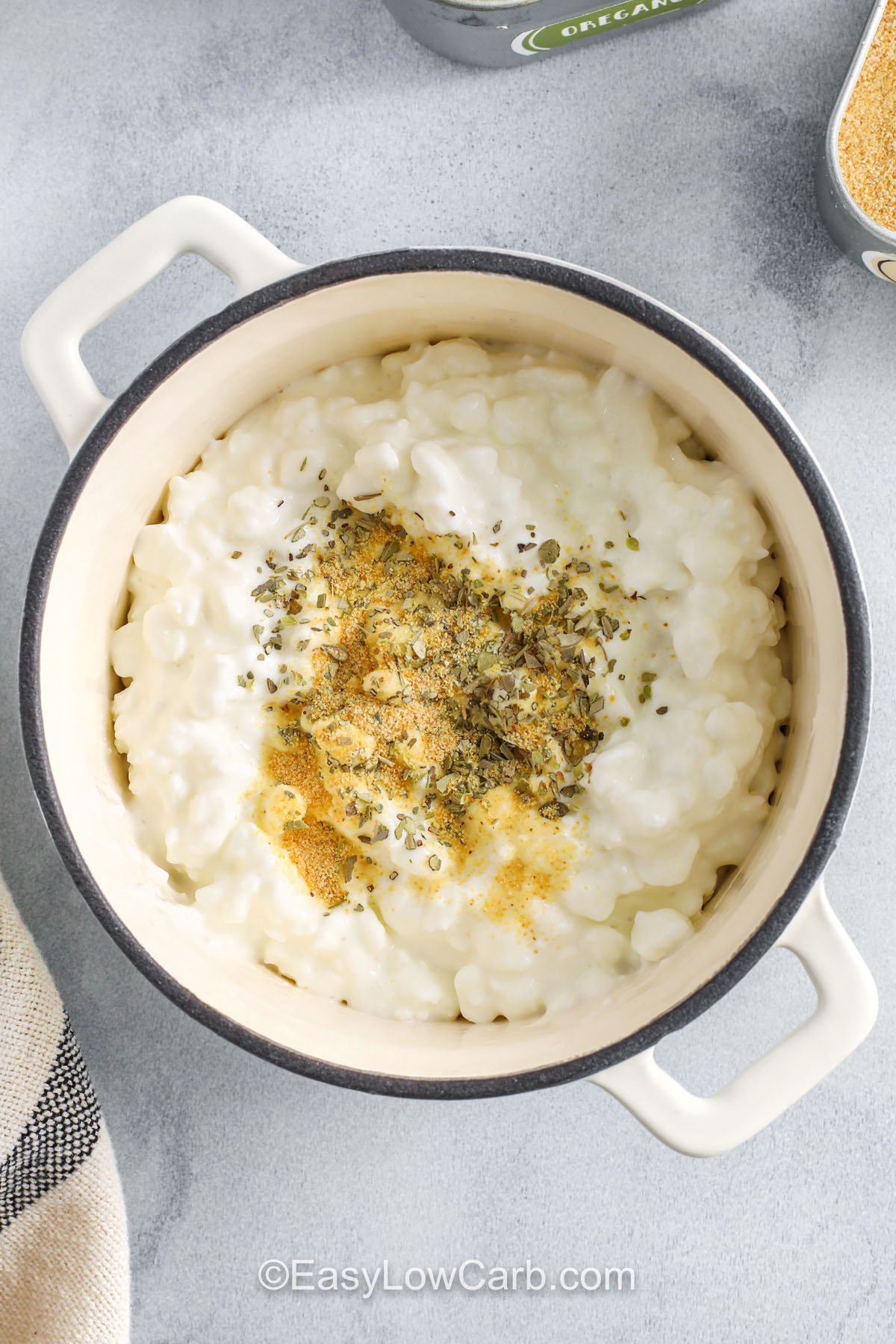 adding seasoning to cottage cheese to make Cottage Cheese Pizza