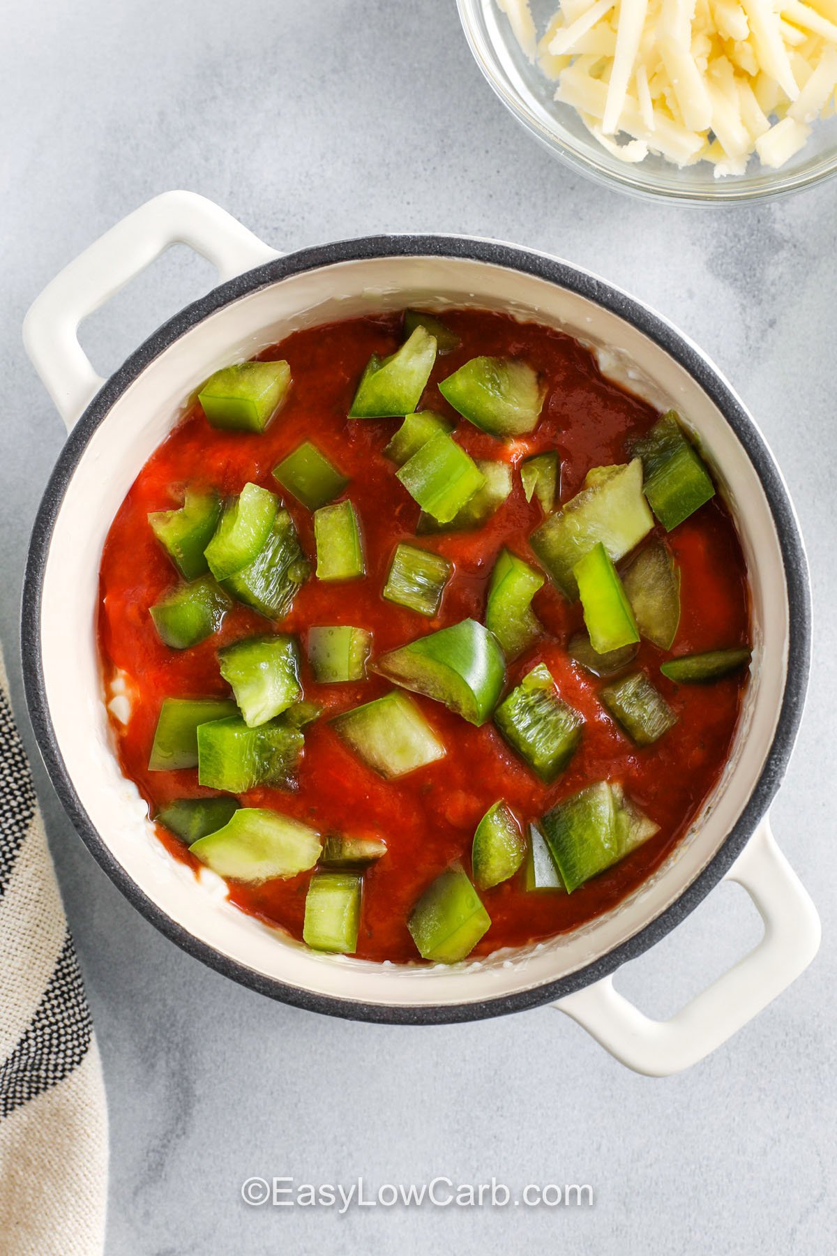 adding tomato sauce and peppers to dish to make Cottage Cheese Pizza