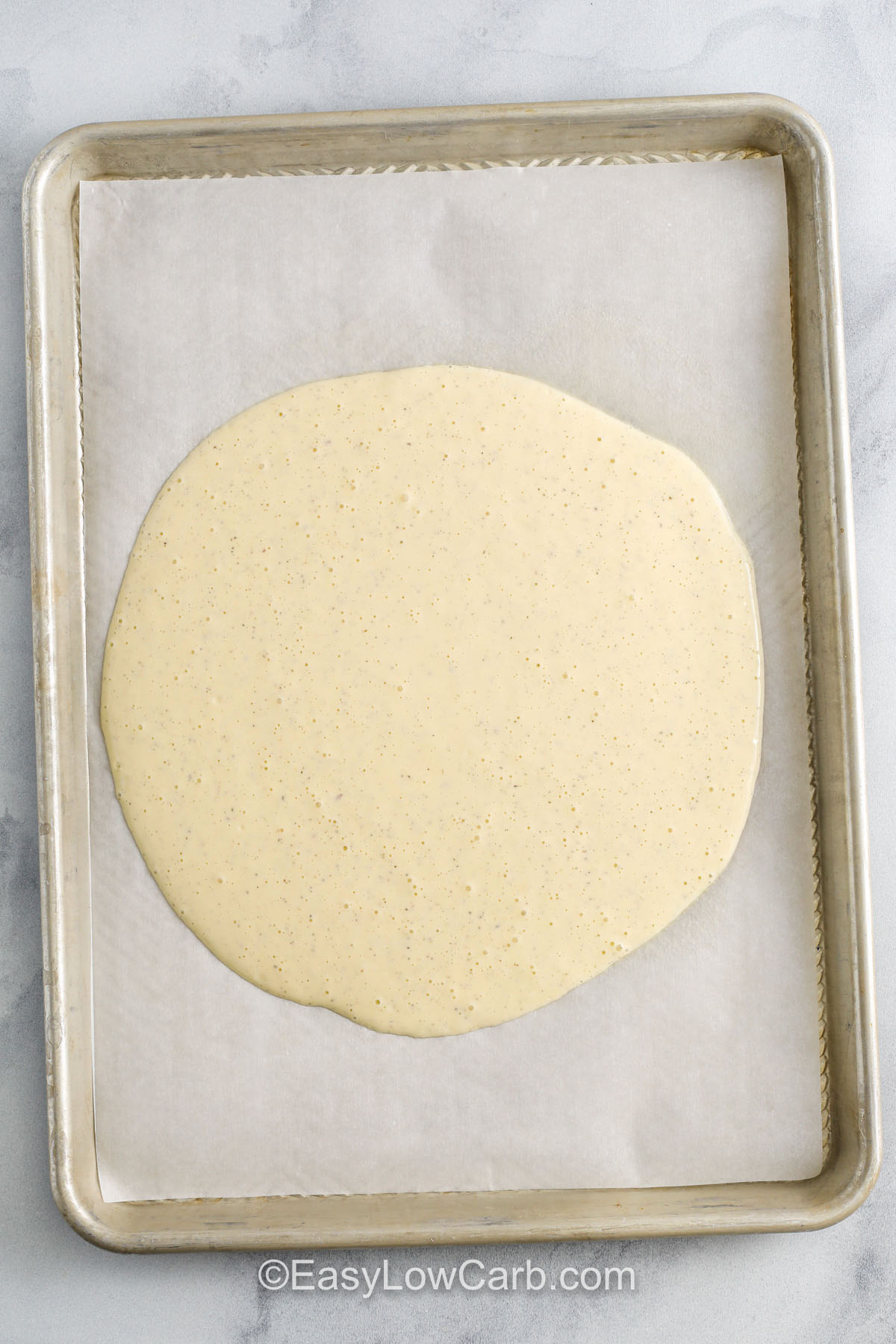 Cottage Cheese Pizza dough on a sheet pan before baking