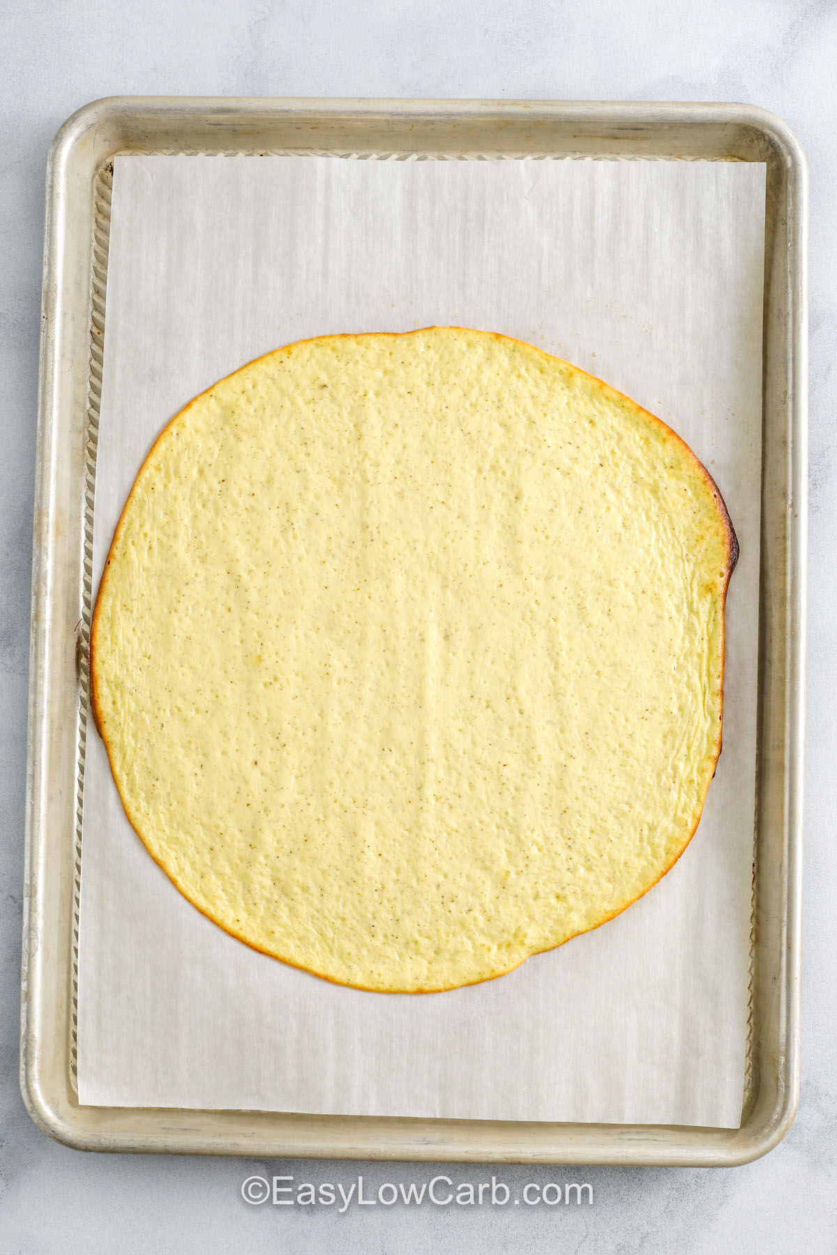 baked Cottage Cheese Pizza crust on a sheet pan