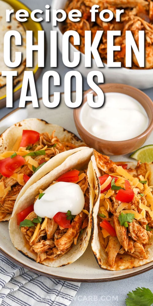 Chicken Tacos on a plate with cheese and sour cream with writing