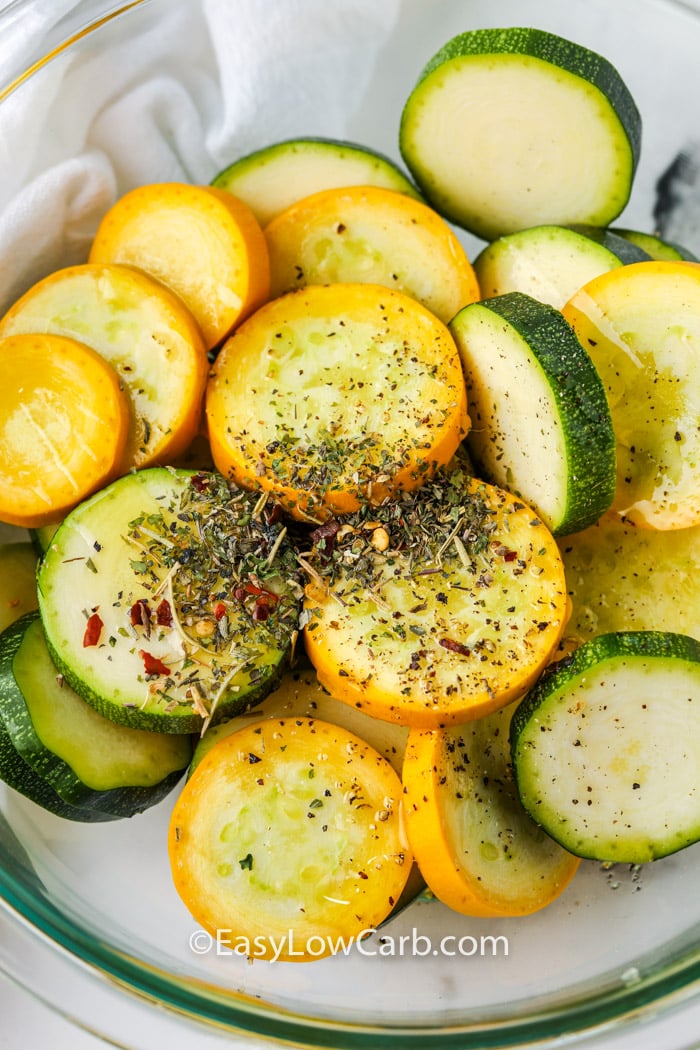 adding seasoning to summer squash to make Air Fryer Squash
