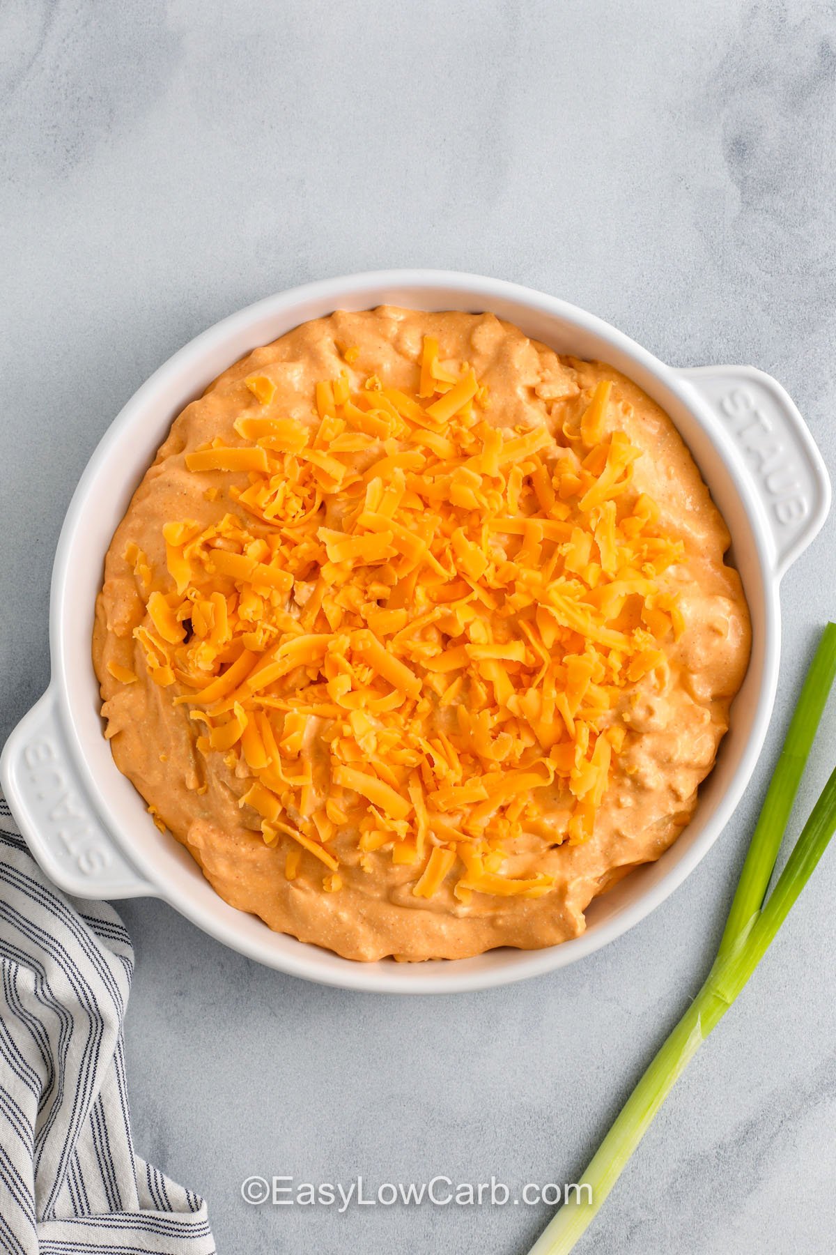 Cottage Cheese Buffalo Chicken Dip in a dish with cheese on top