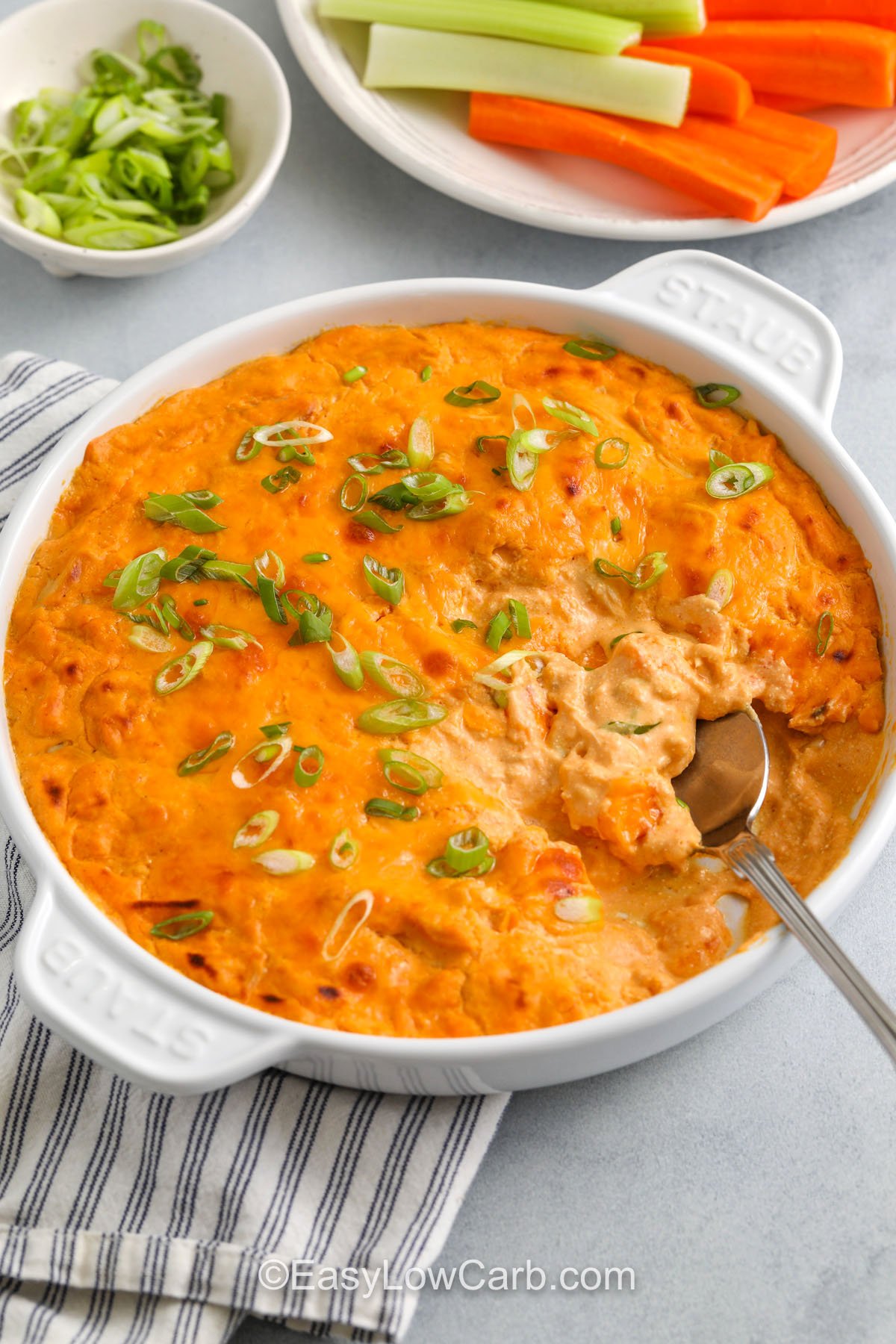 Cottage Cheese Buffalo Chicken Dip in a dish with a spoon