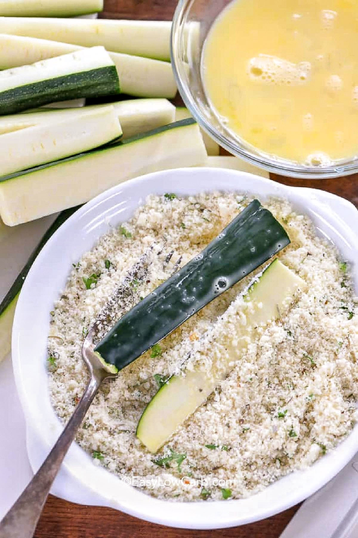 breading zucchini pieces to make Baked Zucchini Fries