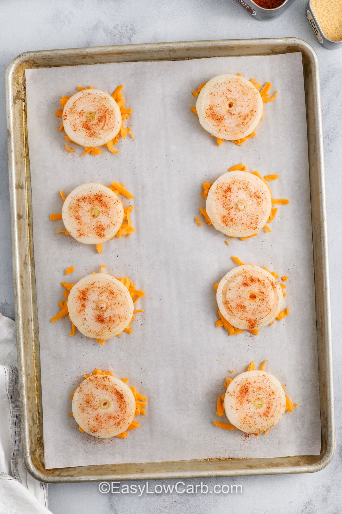 adding seasoning to onions and cheese to make Onion Cheese Chips