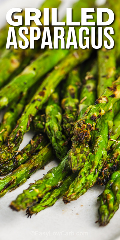 This grilled asparagus recipe is one of the best ways to enjoy fresh veggies. Toss asparagus with olive oil, garlic, and lemon for a zesty flavor, then roast it on the grill until tender-crisp. Sprinkle with parmesan cheese or add crispy bacon for a savory twist. This simple side dish is easy to make and pairs perfectly with grilled meats or fish. #easylowcarb close up of grilled asparagus with text