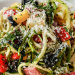 zucchini pasta salad in a bowl with text