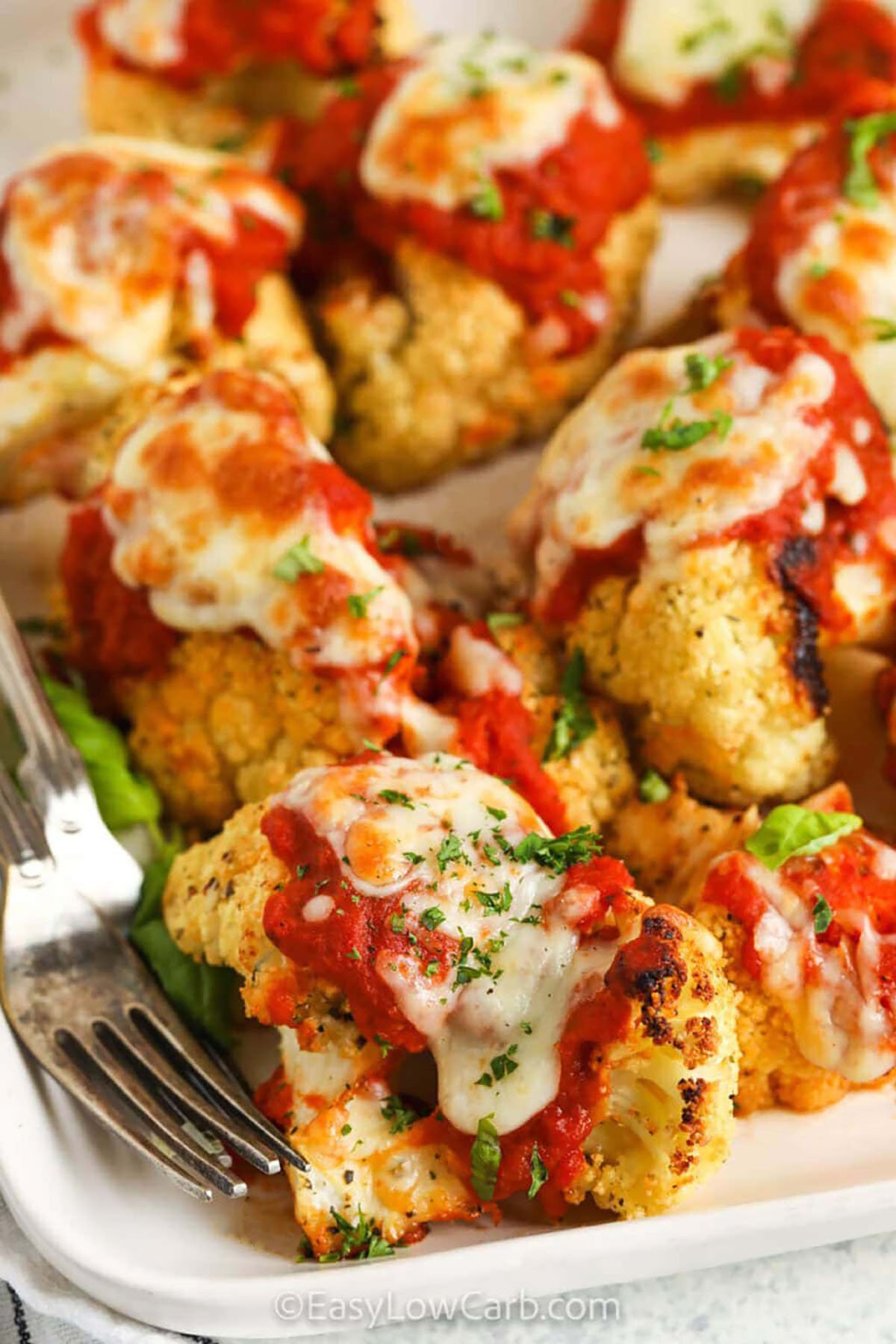 crispy Cauliflower Parmesan on a plate with a fork