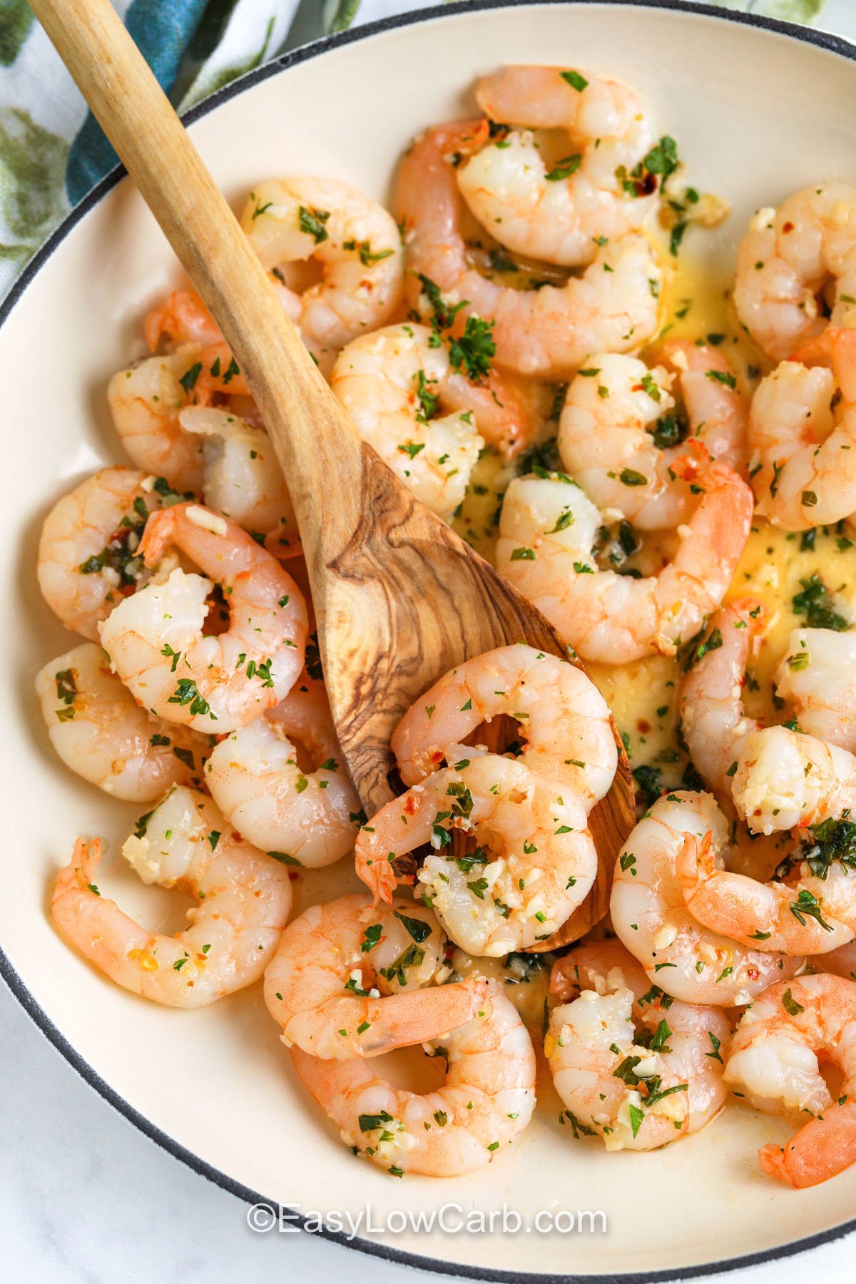 Garlic Butter Shrimp Recipe in the dish with a wooden spoon