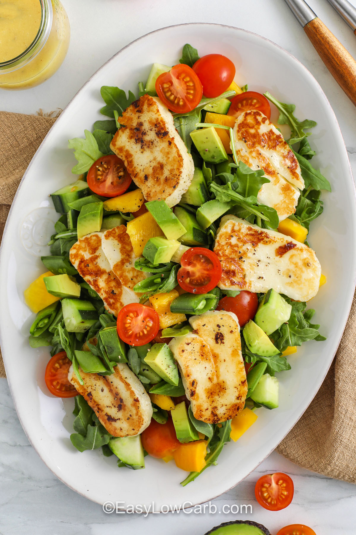 plate of Halloumi Salad with dressing on the side