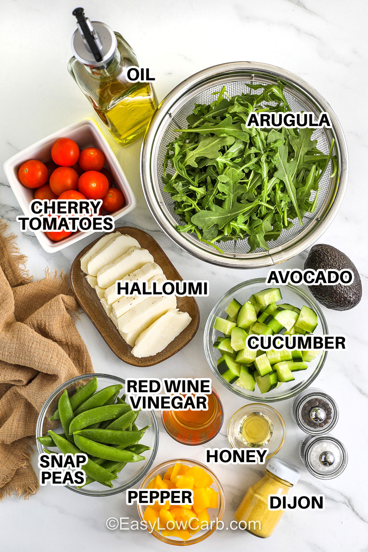 oil , cherry tomatoes , arugula , halloumi , avocado , cucumber , vinegar , honey , snap peas , pepper , dijon , salt and pepper with labels to make Halloumi Salad
