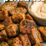 tender Cajun Pork Bites on a plate with writing