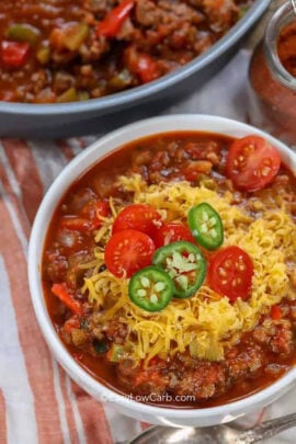 Keto Chili Recipe with cheese , jalapeno slices and tomatoes on top