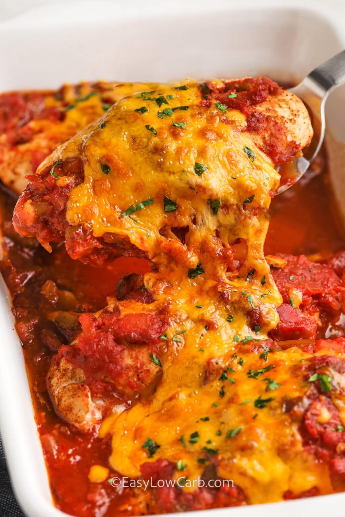 taking a piece of Salsa Chicken Recipe out of the casserole dish