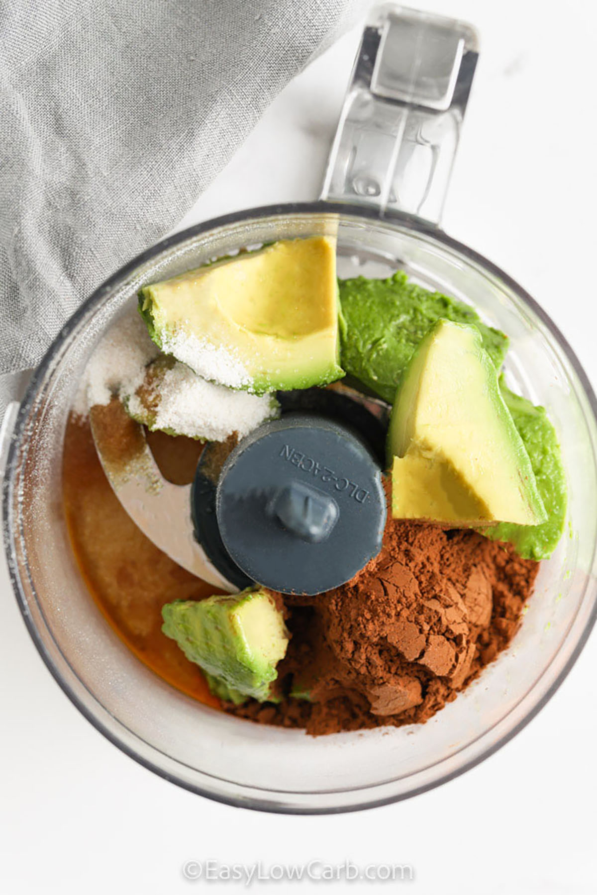adding ingredients to food processor to make Avocado Chocolate Mousse