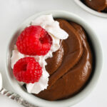 Avocado Chocolate Mousse with raspberries and whipped cream on top