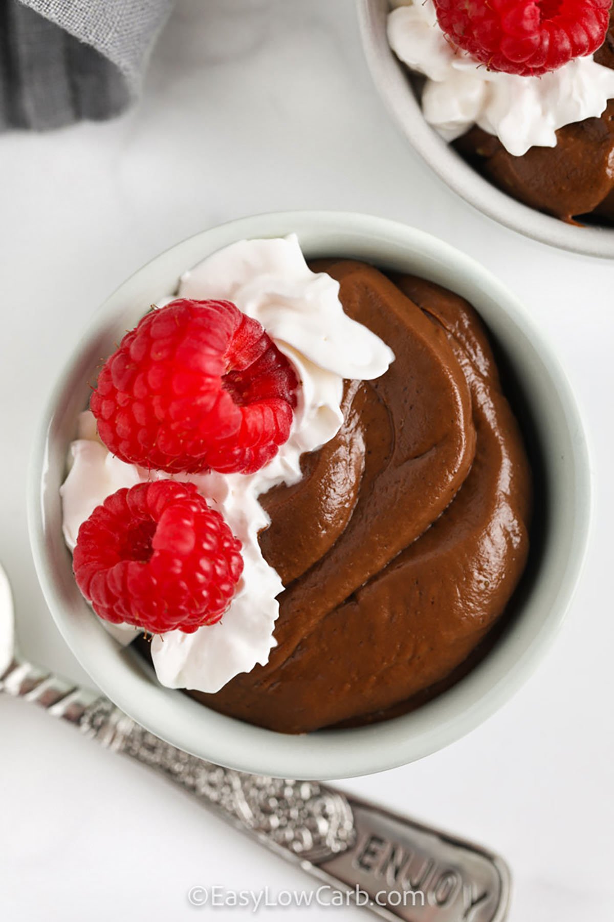 Avocado Chocolate Mousse with raspberries and whipped cream on top