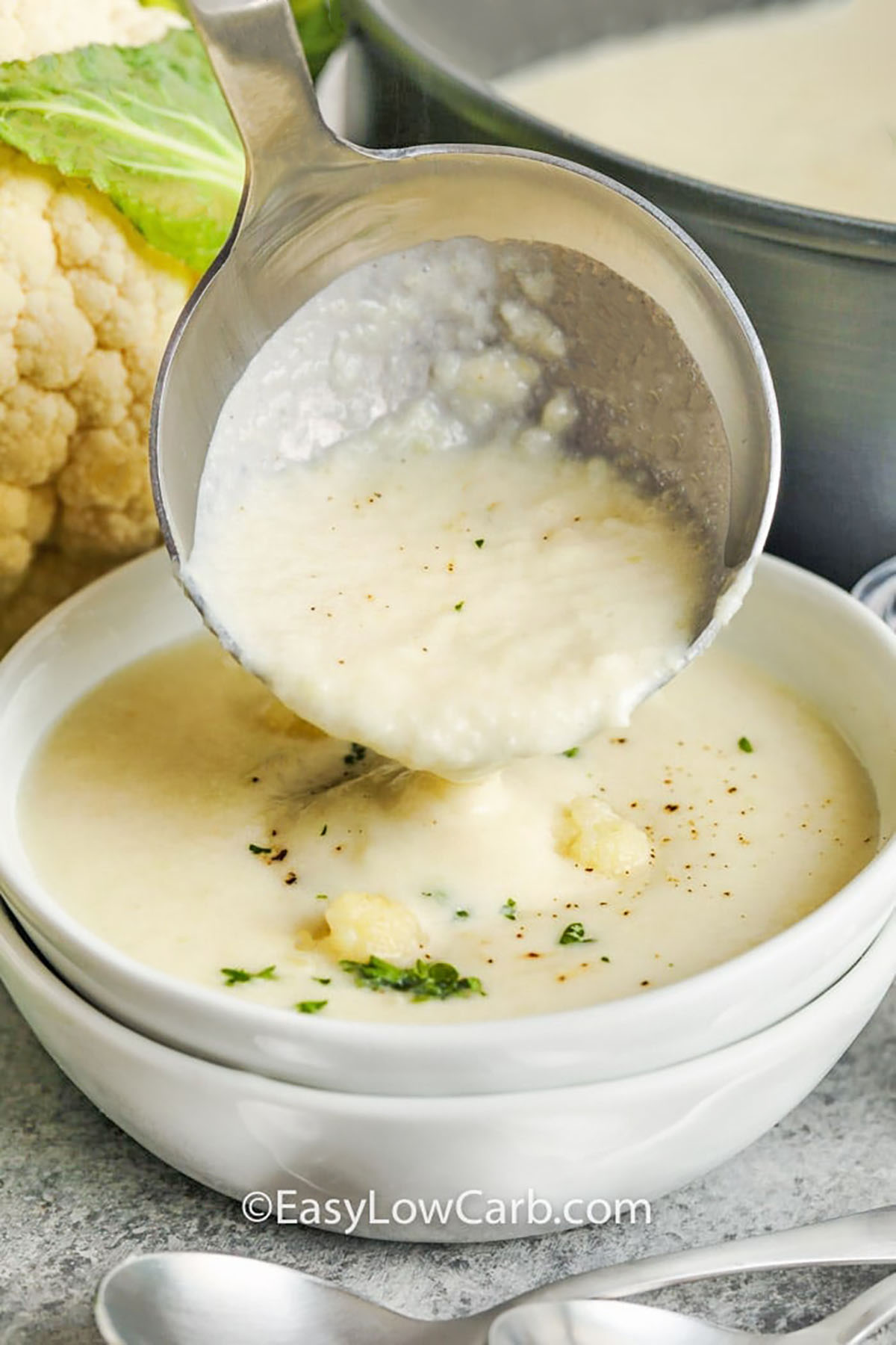pouring Creamy Cauliflower Soup in a bowl