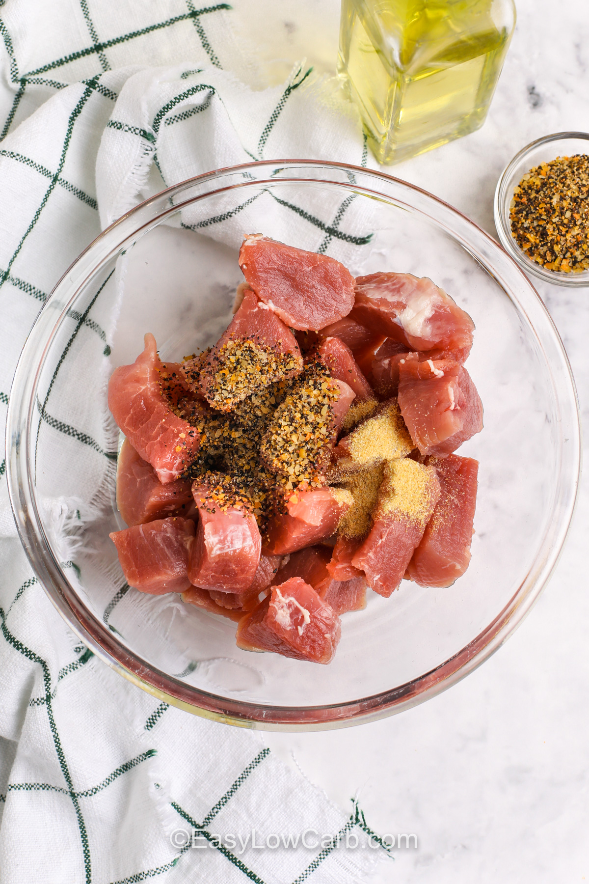 adding seasoning to pork to make Crispy Pork Bites