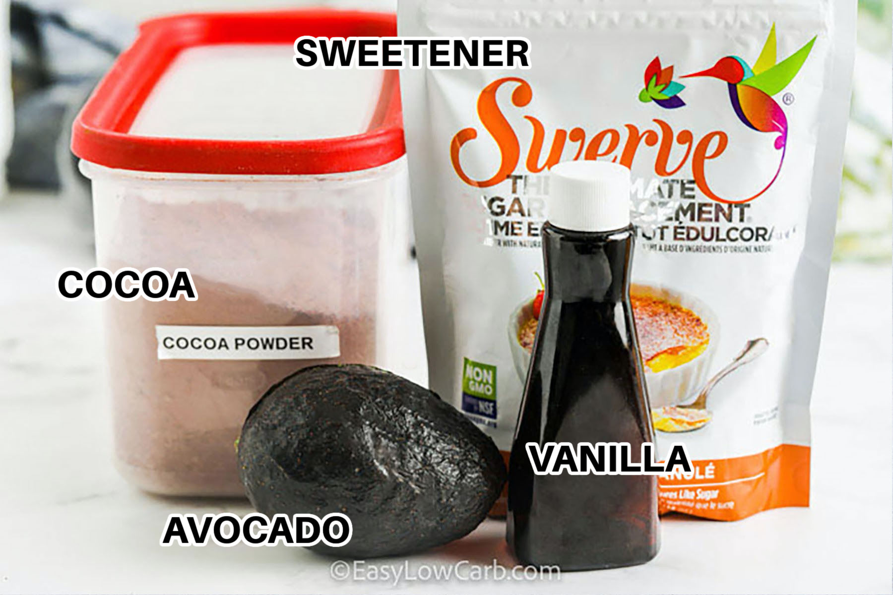 vanilla , avocado , cocoa and sweetener with labels to make Avocado Chocolate Mousse