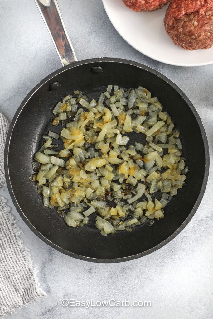 cooking onions to make Lettuce Wrapped Burger