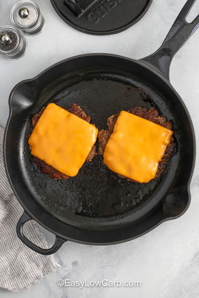 adding cheese to burgers to make Lettuce Wrapped Burger