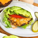 plate of Lettuce Wrapped Burger with butgers and cheese on a plate in the back