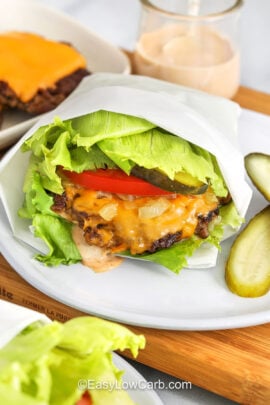 plate of Lettuce Wrapped Burger with butgers and cheese on a plate in the back