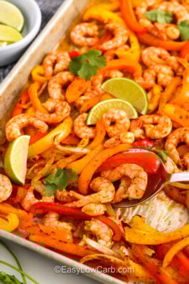 close up of Sheet Pan Shrimp Fajitas on a sheet pan with a spoon